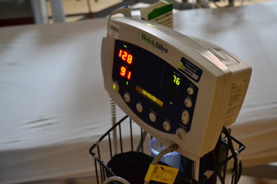 Welch Allyn blood pressure monitor showing 128 / 91 / 76